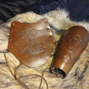 Armskydd i brunt läder med torshammare